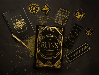 Ruins in Gold Foiled Hardback image that includes merch (Notebook and pen, 4 stickers in Ruins theme, gold foil bookmark, and a signed bookplate.
